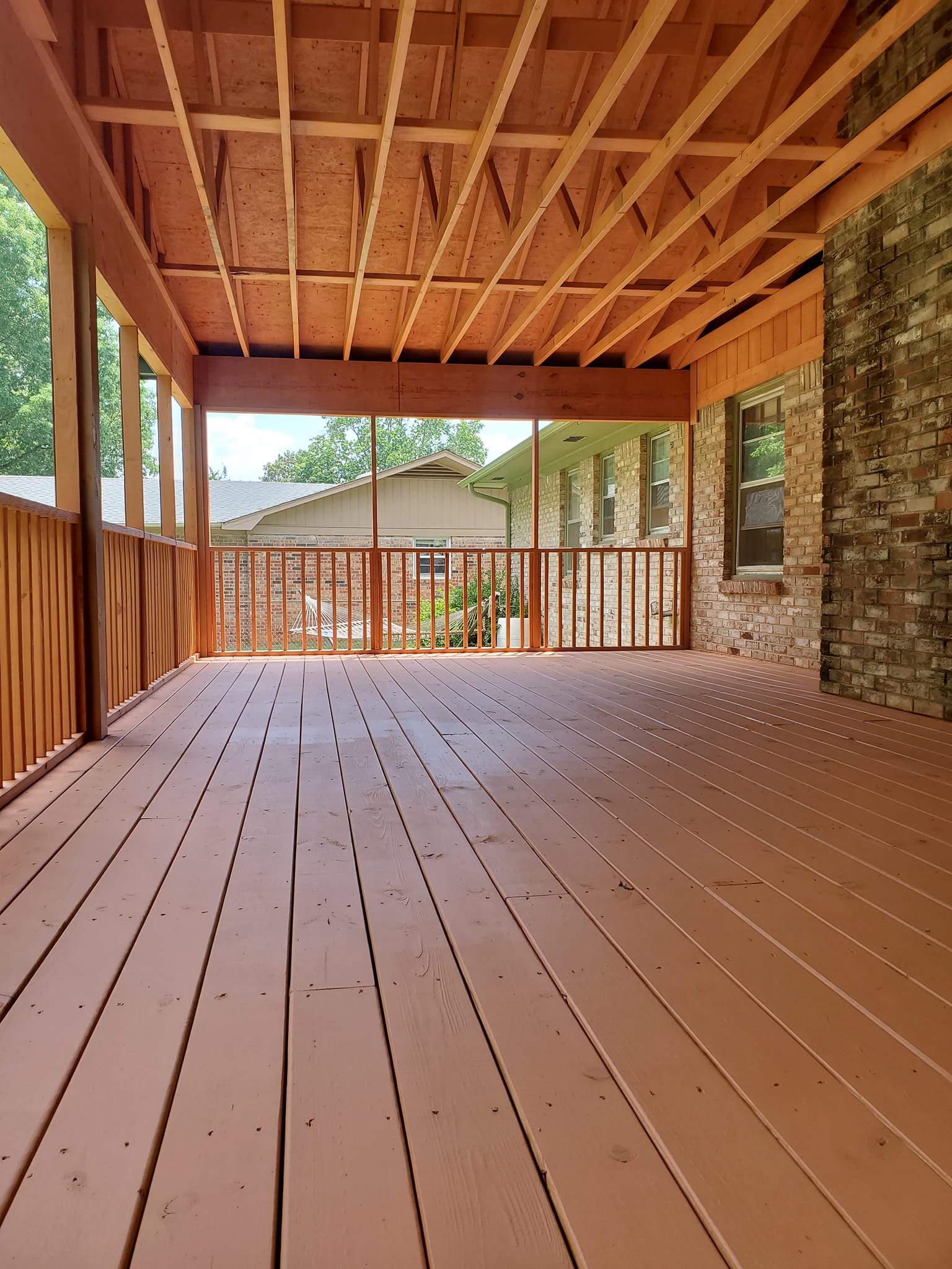 Custom-built garage with brown stucco exterior finished by Paint Pro