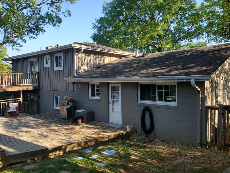 Long white ranch home exterior with covered front porch