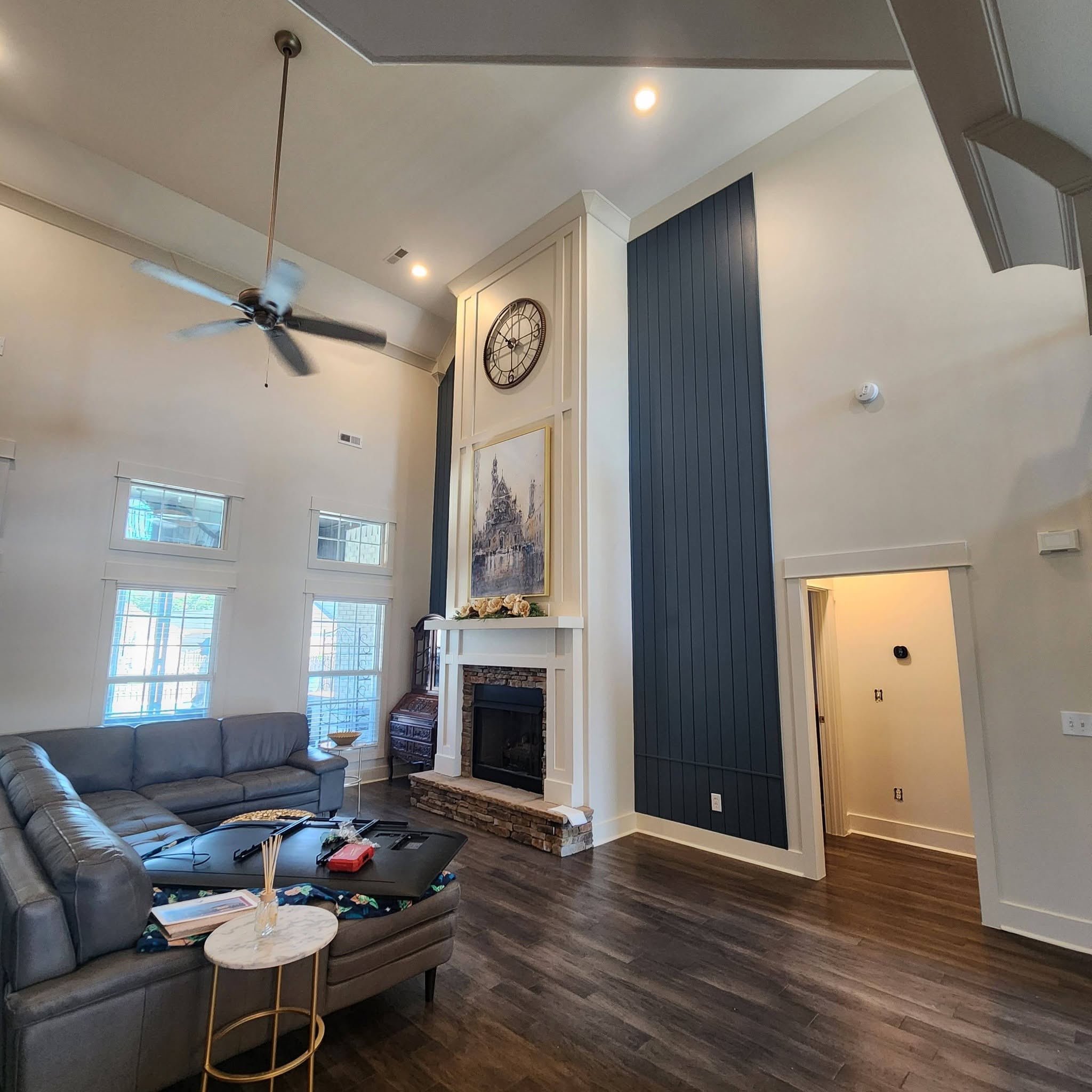 Living room with a tall navy accent wall and fireplace, painted by Paint Pro