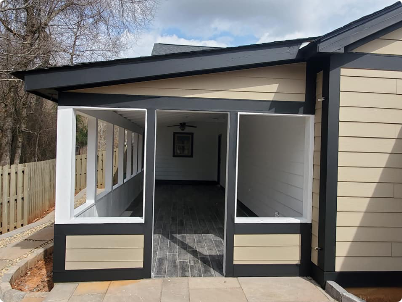 Custom screened porch addition with fresh exterior trim paint, built by the Paint Pro crew