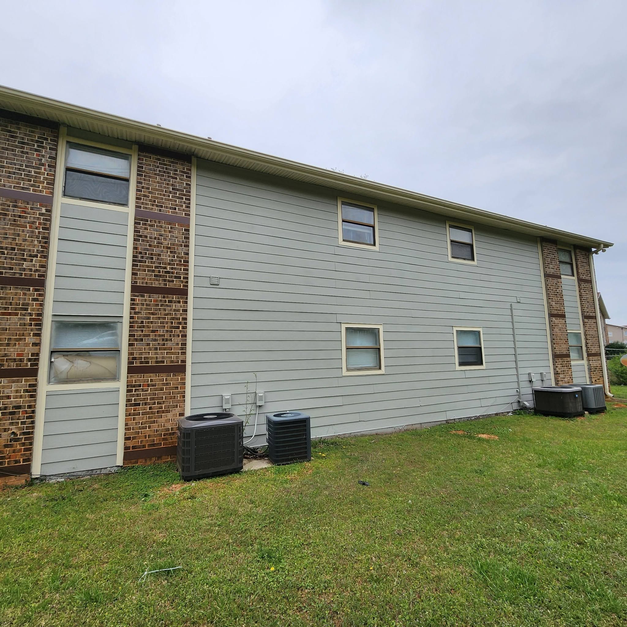 Pressure washing service restoring a home exterior, completed by Paint Pro